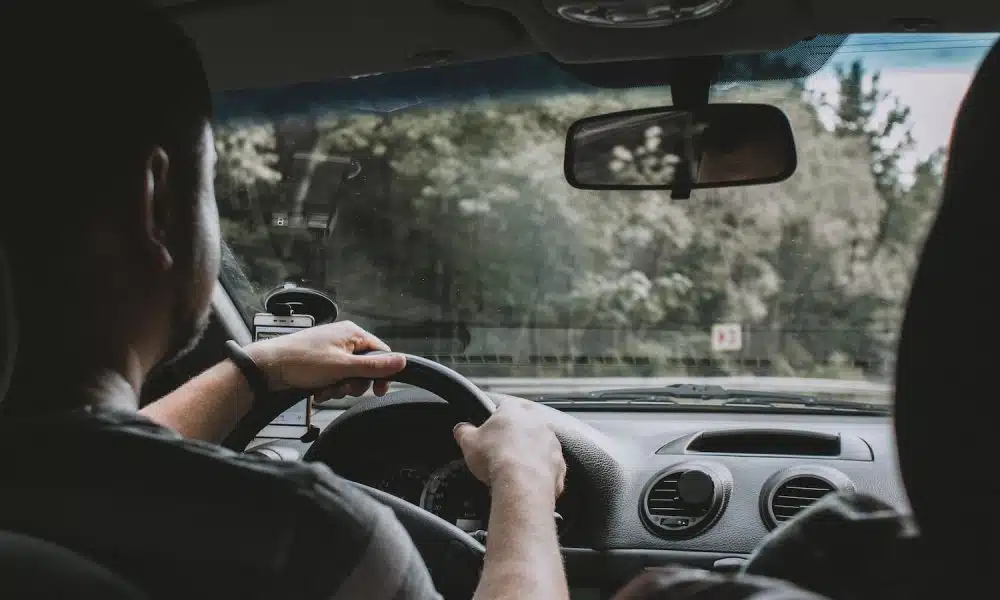 person driving car during daytime