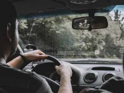 person driving car during daytime