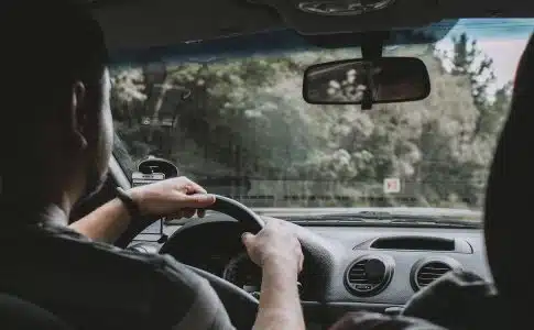 person driving car during daytime